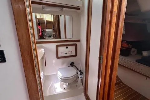 Otter Yacht Photos Pics Bathroom interior of 2000 Catalina 42 Mk II sailboat with wooden accents and compact design.