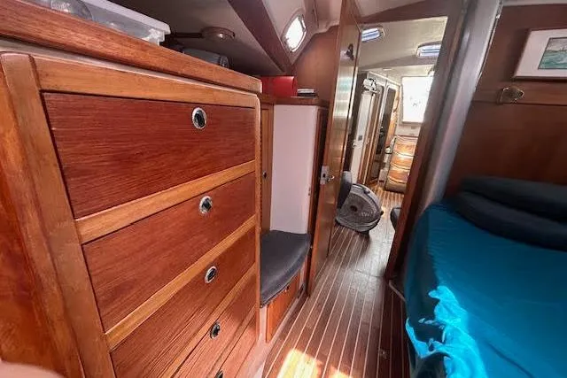 Otter Yacht Photos Pics Interior of 2000 Catalina 42 Mk II sailboat with wooden cabinetry and blue bedding.