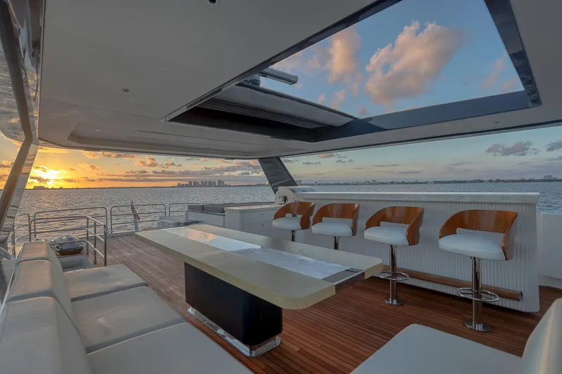 Our Trade Yacht Photos Pics Luxurious 2021 Sirena 88 yacht interior with sunset view, featuring elegant seating and modern design.