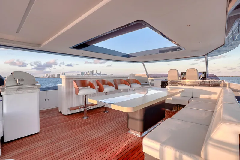 Our Trade Yacht Photos Pics Luxurious 2021 Sirena 88 yacht deck with seating, table, and ocean view.