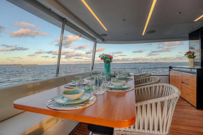 Our Trade Yacht Photos Pics Luxurious dining area on 2021 Sirena 88 yacht with ocean view and elegant table setting.