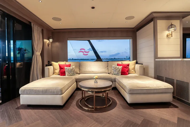 Our Trade Yacht Photos Pics Luxurious interior of 2021 Sirena 88 yacht with elegant beige sofa and sea view.