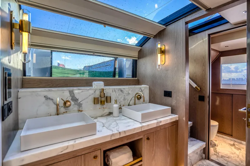 Our Trade Yacht Photos Pics Luxurious Sirena 88 yacht bathroom with marble sinks and skylight, 2021 model.