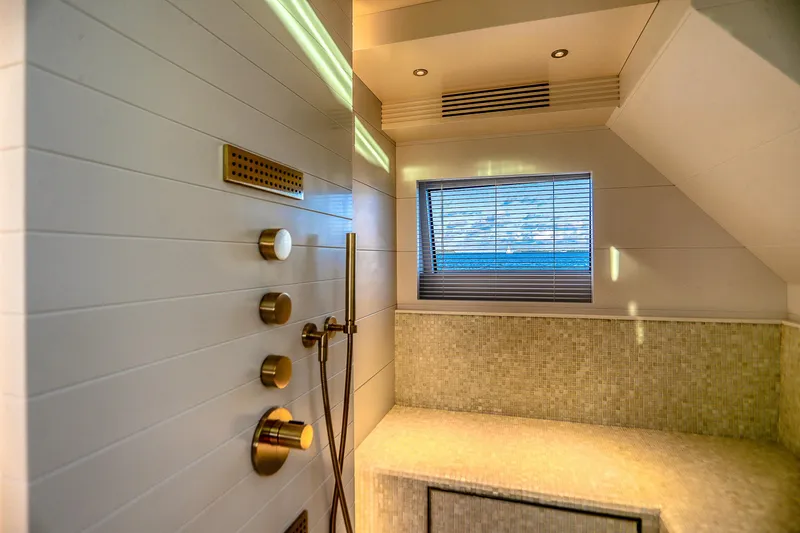 Our Trade Yacht Photos Pics Luxurious bathroom interior on 2021 Sirena 88 yacht, featuring modern shower controls and window view.