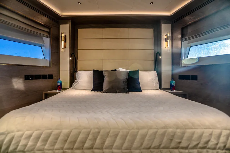 Our Trade Yacht Photos Pics Luxurious bedroom interior of 2021 Sirena 88 yacht with elegant bedding and ambient lighting.