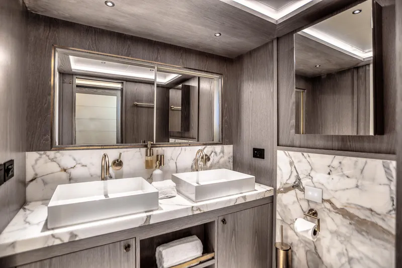 Our Trade Yacht Photos Pics Luxurious bathroom in 2021 Sirena 88 yacht with dual sinks and marble accents.