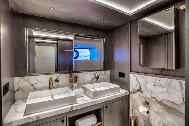 Our Trade Yacht Photos Pics Luxurious bathroom in 2021 Sirena 88 yacht with dual sinks and marble accents.