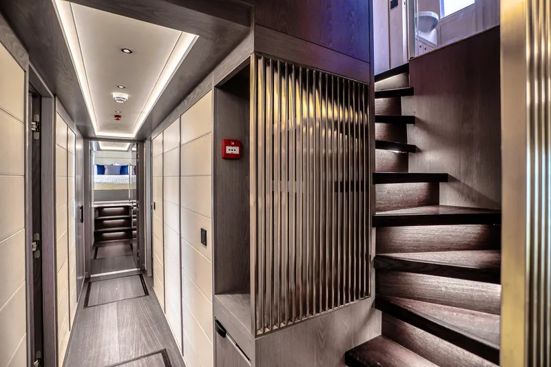 Our Trade Yacht Photos Pics Luxurious interior of 2021 Sirena 88 yacht featuring modern hallway and elegant staircase.