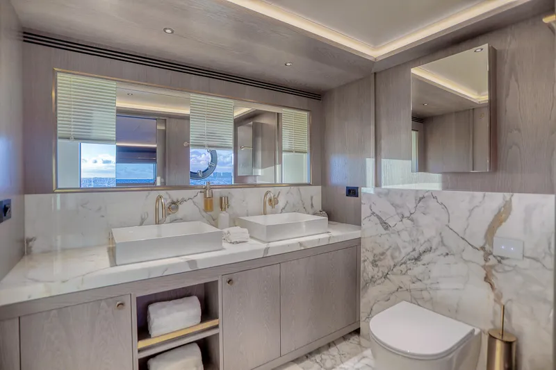 Our Trade Yacht Photos Pics Luxurious bathroom in 2021 Sirena 88 yacht with marble accents and dual sinks.