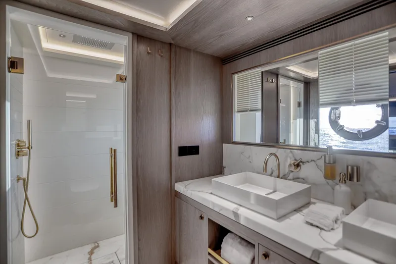 Our Trade Yacht Photos Pics Luxurious bathroom on 2021 Sirena 88 yacht with marble sink and modern shower.