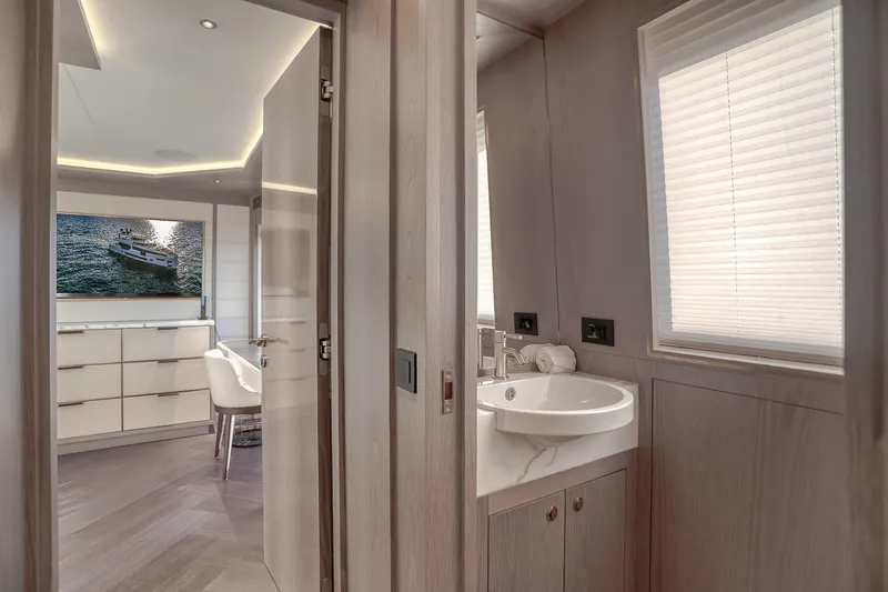 Our Trade Yacht Photos Pics Luxurious interior of 2021 Sirena 88 yacht featuring modern bathroom and elegant living space.