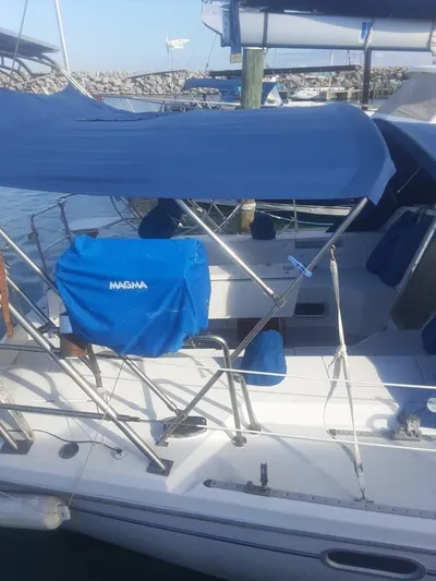 Otter Yacht Photos Pics Catalina 42 Mk II 2000 sailboat docked at marina with blue canopy and Magma grill.