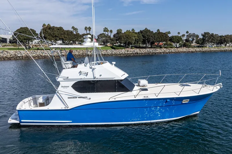  Yacht Photos Pics 1974 Hatteras Convertible Sportfisher boat on water, blue and white design, scenic background.