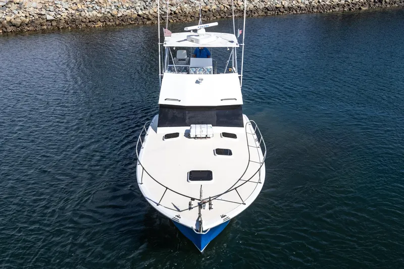  Yacht Photos Pics 1974 Hatteras Convertible Sportfisher boat on calm water, viewed from the front.