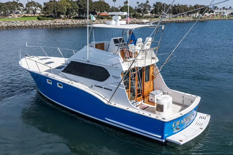 Yacht Photos Pics 1974 Hatteras Convertible Sportfisher boat with blue hull on calm water.