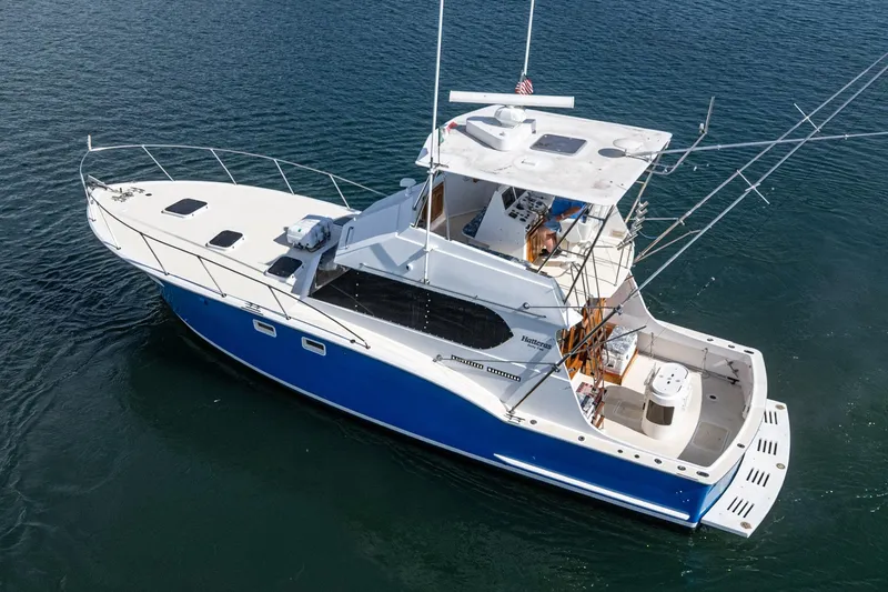 Yacht Photos Pics 1974 Hatteras Convertible Sportfisher boat on water, featuring a sleek blue and white design.