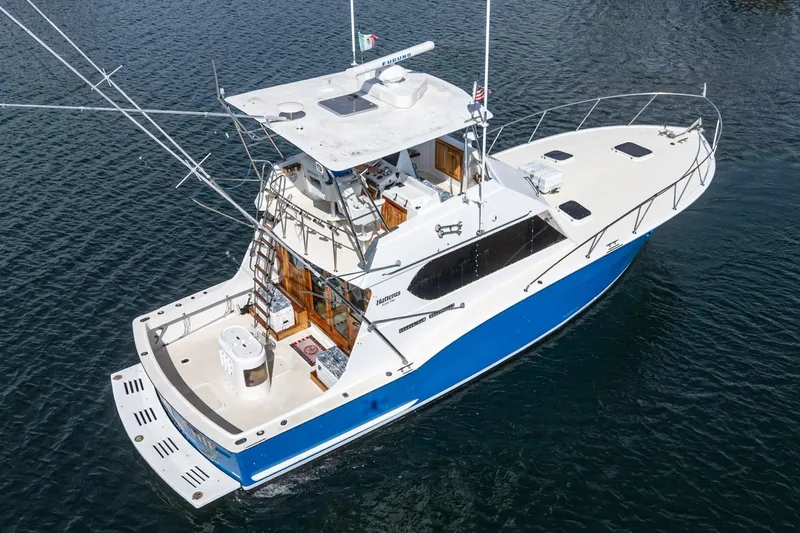  Yacht Photos Pics 1974 Hatteras Convertible Sportfisher boat on water, featuring a blue and white design.