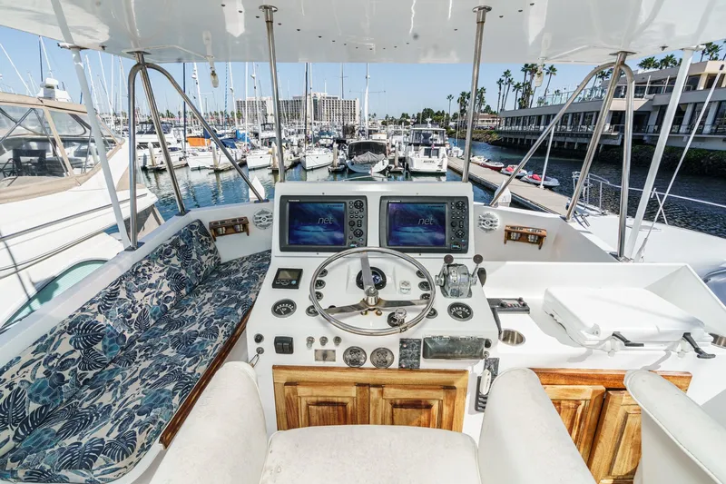  Yacht Photos Pics 1974 Hatteras Convertible Sportfisher yacht helm with marina view, featuring navigation equipment.