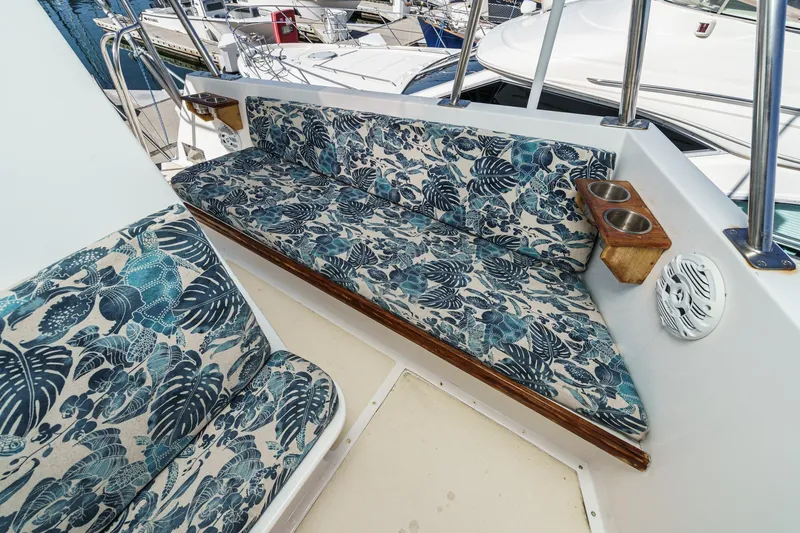  Yacht Photos Pics 1974 Hatteras Convertible Sportfisher boat seating with tropical-patterned cushions and cup holders.