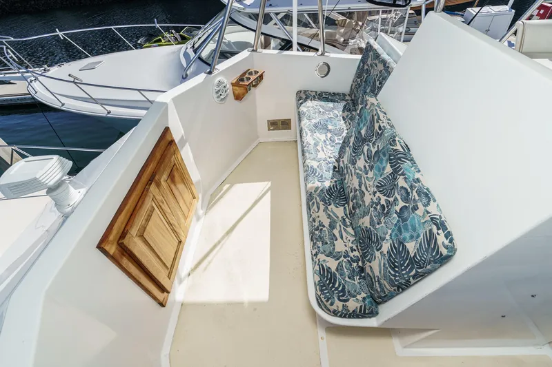  Yacht Photos Pics 1974 Hatteras Convertible Sportfisher boat with floral-patterned seating on deck.