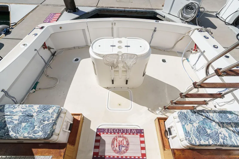  Yacht Photos Pics 1974 Hatteras Convertible Sportfisher boat deck with floral cushions and welcome mat.