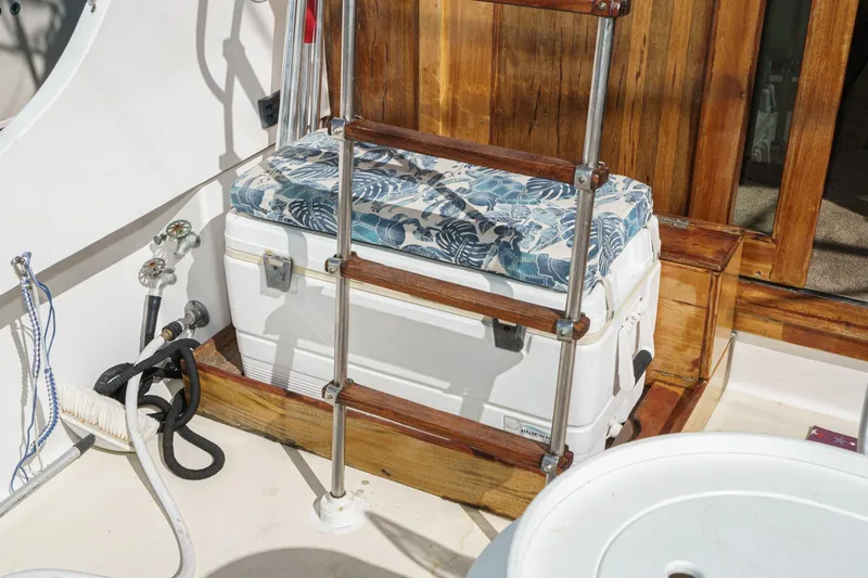  Yacht Photos Pics 1974 Hatteras Convertible Sportfisher deck with cushioned cooler and wooden ladder.