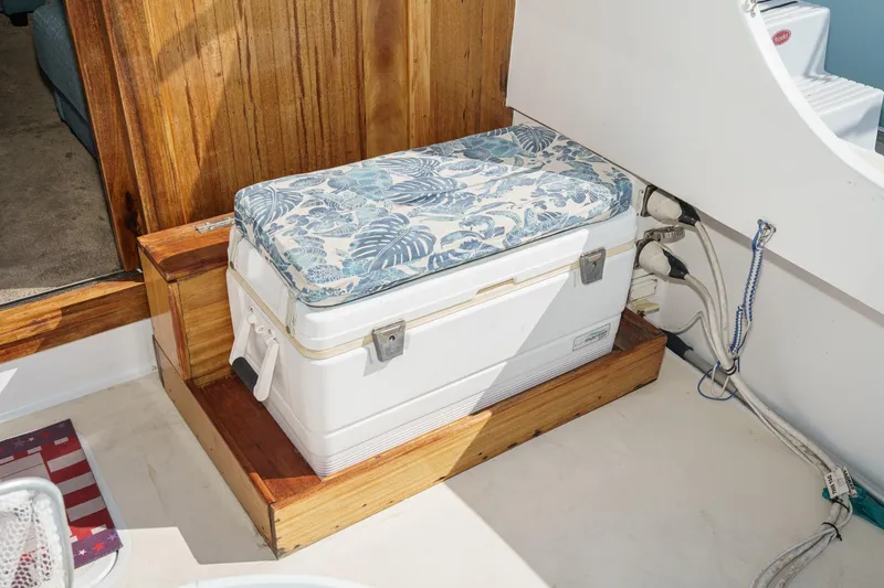  Yacht Photos Pics 1974 Hatteras Convertible Sportfisher interior with cushioned cooler seat and wooden accents.