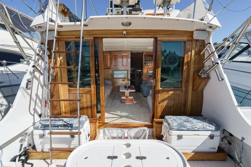  Yacht Photos Pics 1974 Hatteras Convertible Sportfisher yacht interior with wooden accents and seating area.