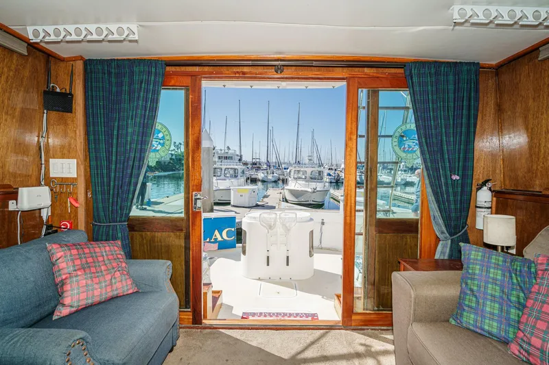  Yacht Photos Pics 1974 Hatteras Convertible Sportfisher interior with marina view through glass doors.