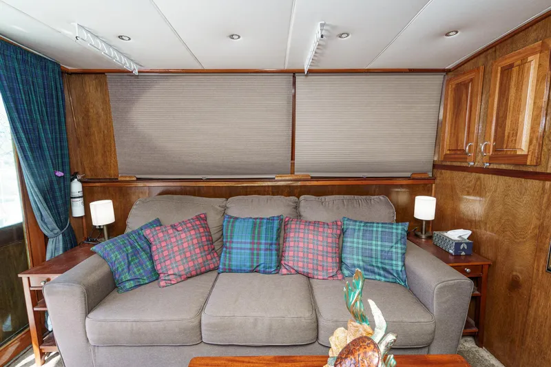  Yacht Photos Pics Interior of 1974 Hatteras Convertible Sportfisher with plaid cushions and wooden cabinetry.