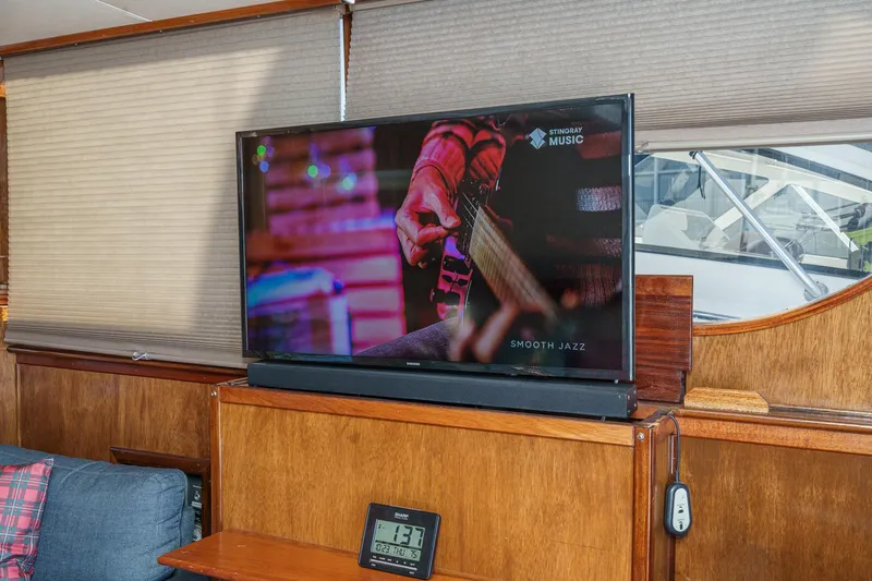  Yacht Photos Pics Interior of 1974 Hatteras Convertible Sportfisher with TV displaying smooth jazz music.