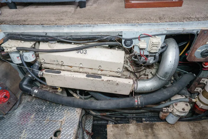  Yacht Photos Pics Engine compartment of a 1974 Hatteras Convertible Sportfisher, showcasing mechanical components and wiring.