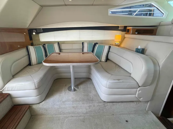 Lost Bouys Yacht Photos Pics Luxurious interior of 2004 Regal Commodore 3880 yacht with plush seating and elegant table.