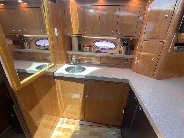 Lost Bouys Yacht Photos Pics Luxurious 2004 Regal Commodore 3880 yacht kitchen with wood cabinetry and modern amenities.