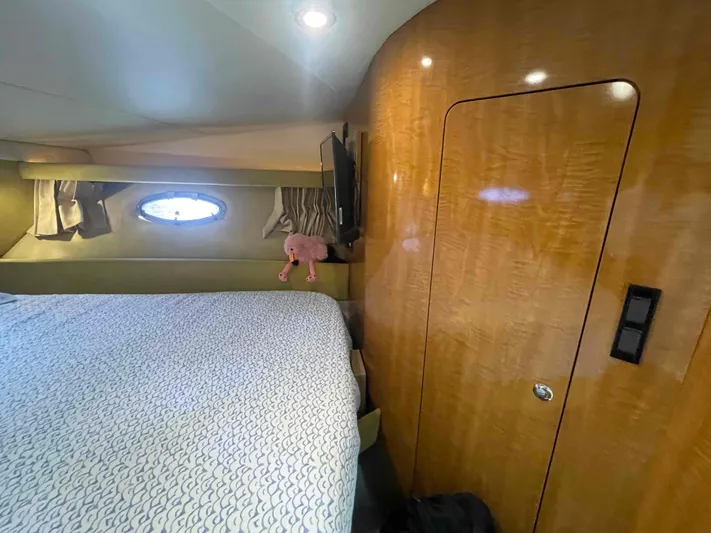 Lost Bouys Yacht Photos Pics Cozy cabin interior of 2004 Regal Commodore 3880 yacht with bed and porthole.