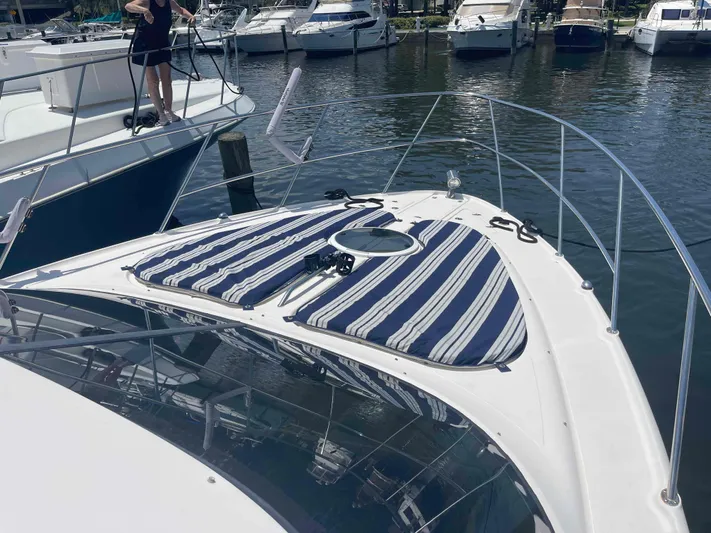 Lost Bouys Yacht Photos Pics 2004 Regal Commodore 3880 yacht with striped sun pads docked at marina.