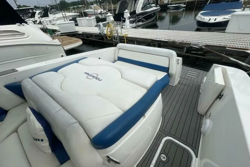 Yacht Photos Pics 2006 Fountain 48 Express Cruiser with white and blue seating at a marina dock.