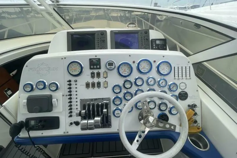  Yacht Photos Pics 2006 Fountain 48 Express Cruiser dashboard with gauges, controls, and steering wheel.