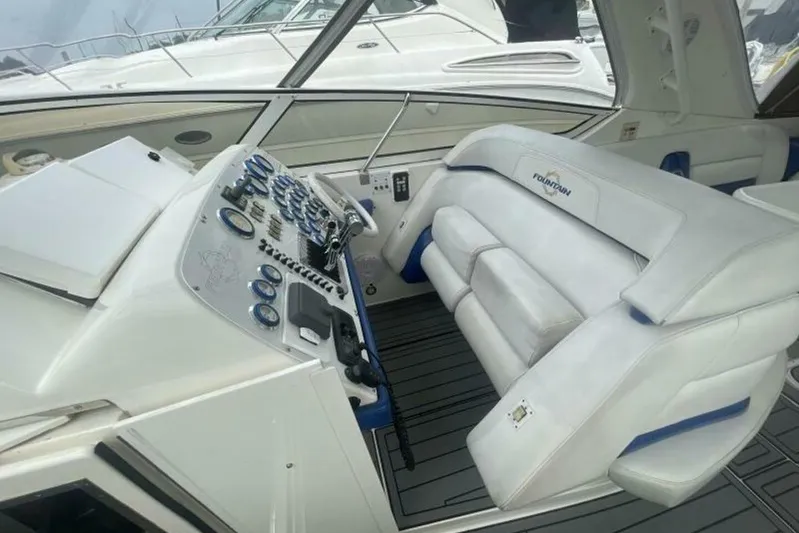  Yacht Photos Pics 2006 Fountain 48 Express Cruiser cockpit with white seating and control panel.