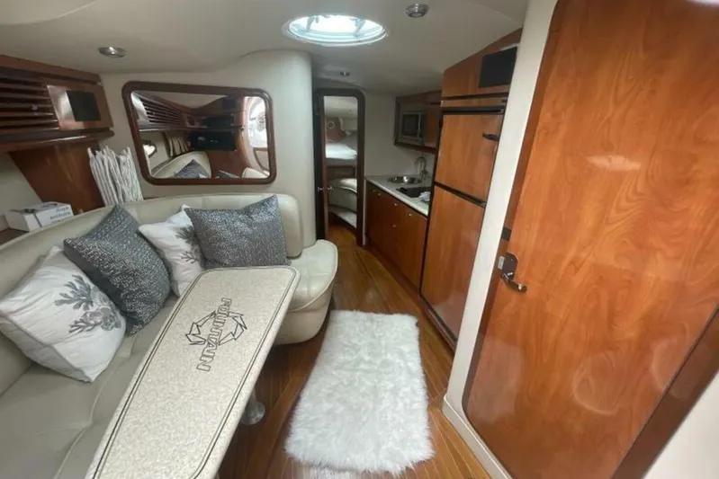  Yacht Photos Pics 2006 Fountain 48 Express Cruiser interior with plush seating, kitchenette, and wood accents.