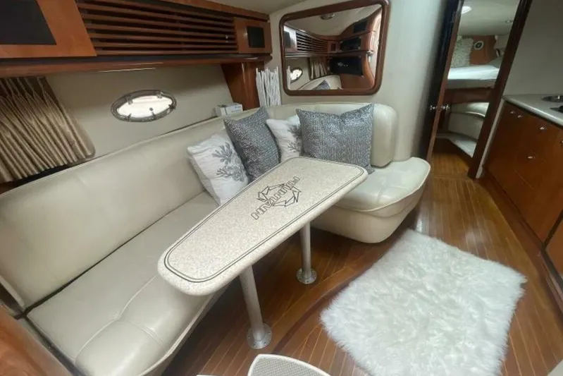  Yacht Photos Pics Interior of 2006 Fountain 48 Express Cruiser with elegant seating and wooden flooring.