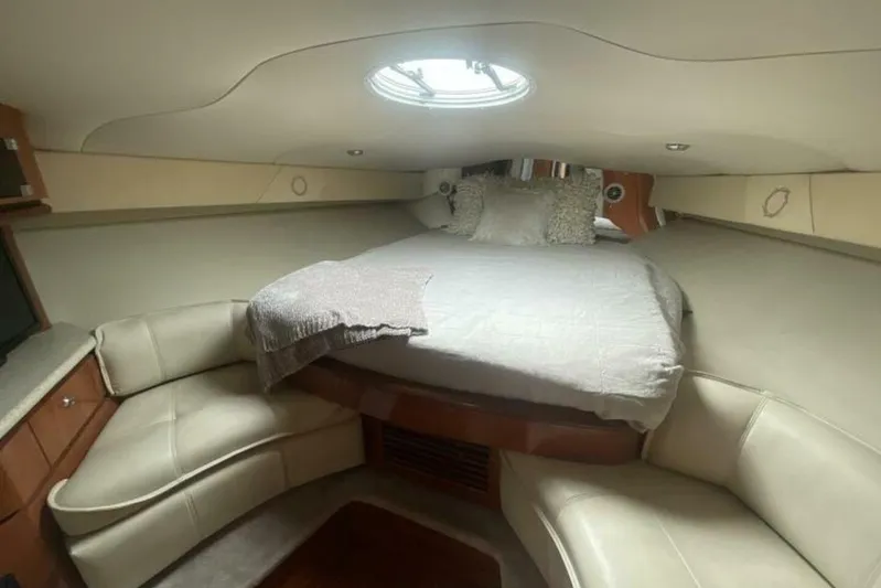  Yacht Photos Pics Interior cabin of 2006 Fountain 48 Express Cruiser with bed and seating area.