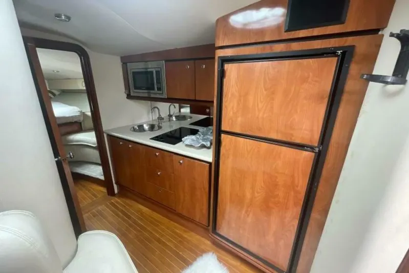  Yacht Photos Pics 2006 Fountain 48 Express Cruiser interior kitchen with wood cabinetry and modern appliances.