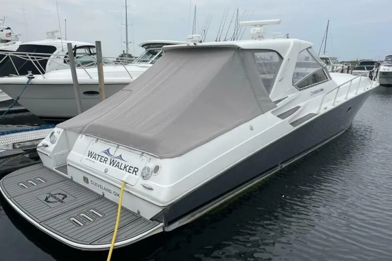  Yacht Photos Pics 2006 Fountain 48 Express Cruiser docked, rear view with cover, named "Water Walker."