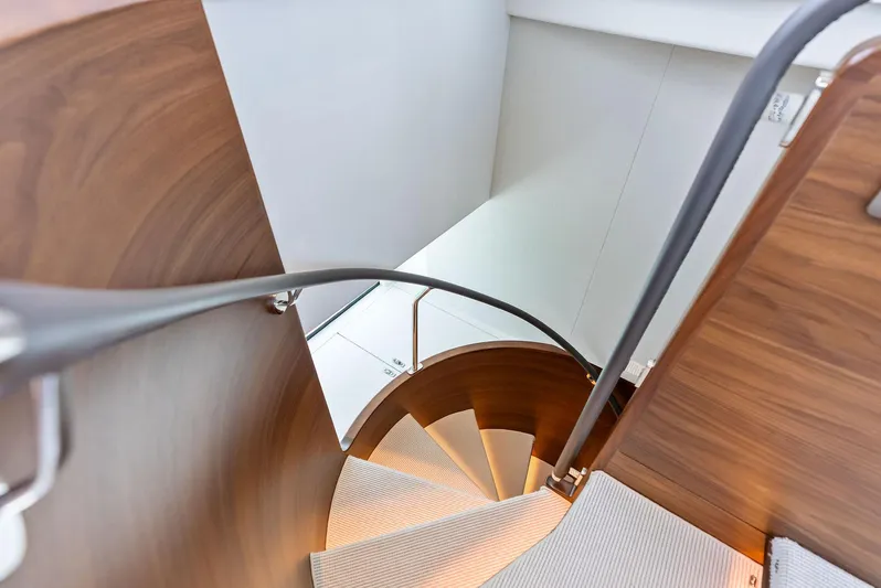 Seaquel Yacht Photos Pics Spiral staircase on 2024 Princess Y72 Motor Yacht, featuring elegant wood and modern design.