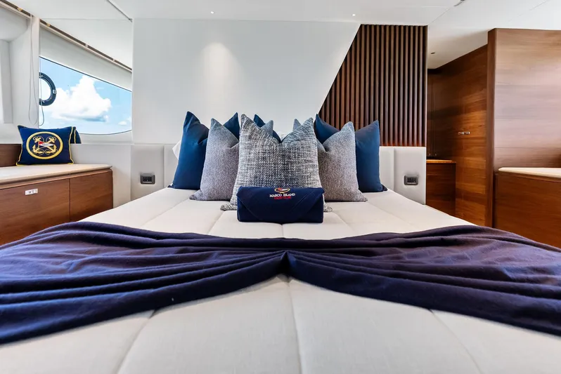Seaquel Yacht Photos Pics Luxurious bedroom interior of 2024 Princess Y72 Motor Yacht with elegant pillows and wooden accents.