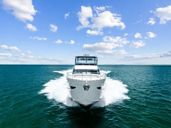 Seaquel Yacht Photos Pics 2024 Princess Y72 Motor Yacht cruising on open sea under blue sky.