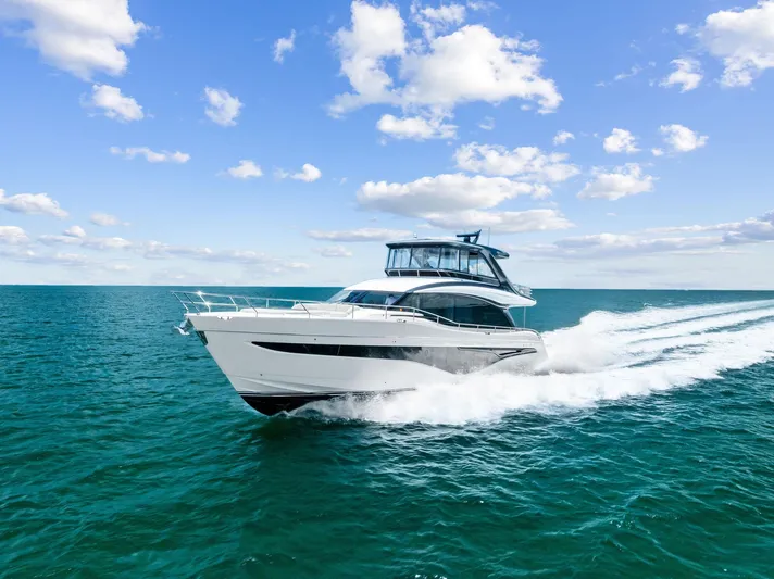 Seaquel Yacht Photos Pics 2024 Princess Y72 Motor Yacht cruising on open sea under blue sky.