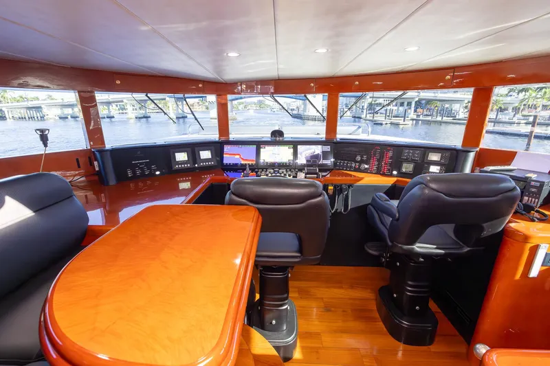 Kaya Yacht Photos Pics Luxurious 2003 Johnson 87 yacht helm with modern navigation equipment and plush seating.