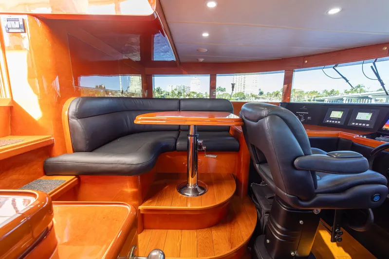 Kaya Yacht Photos Pics Luxurious 2003 Johnson 87 yacht interior with leather seating and polished wood finishes.